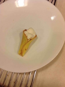 A single completed Geneve wafer that is delicious and also very pretty, golden yellow and whipped cream.