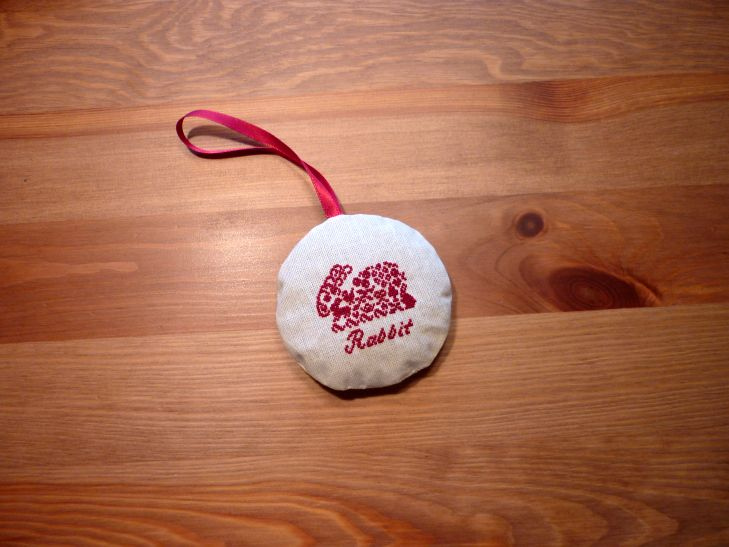 A lavender sachet with an embroidered rabbit
